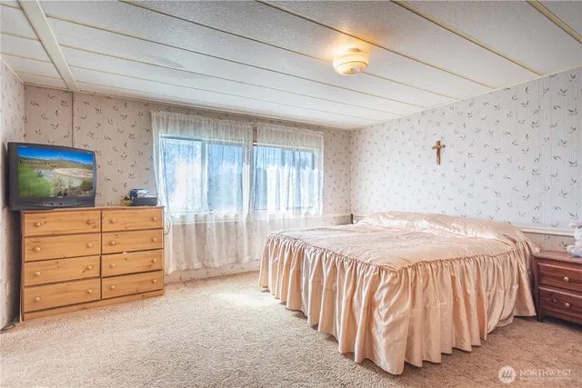 a bedroom with a bed and a cabinets