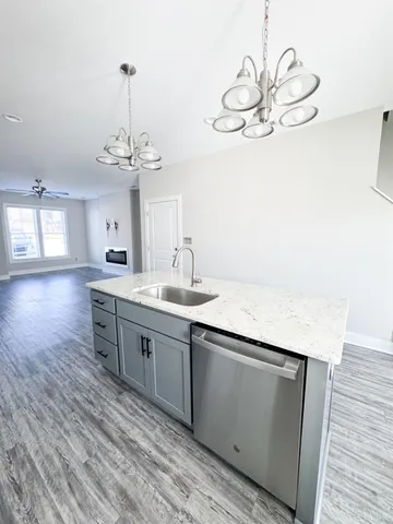 a spacious bathroom with a granite countertop sink a toilet and a mirror