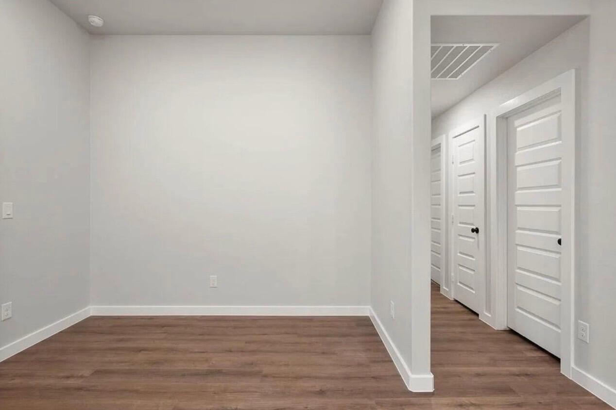 1708 145th Street Lubbock, TX 79423 - Photo 12 of 19 a view of an empty room with wooden floor