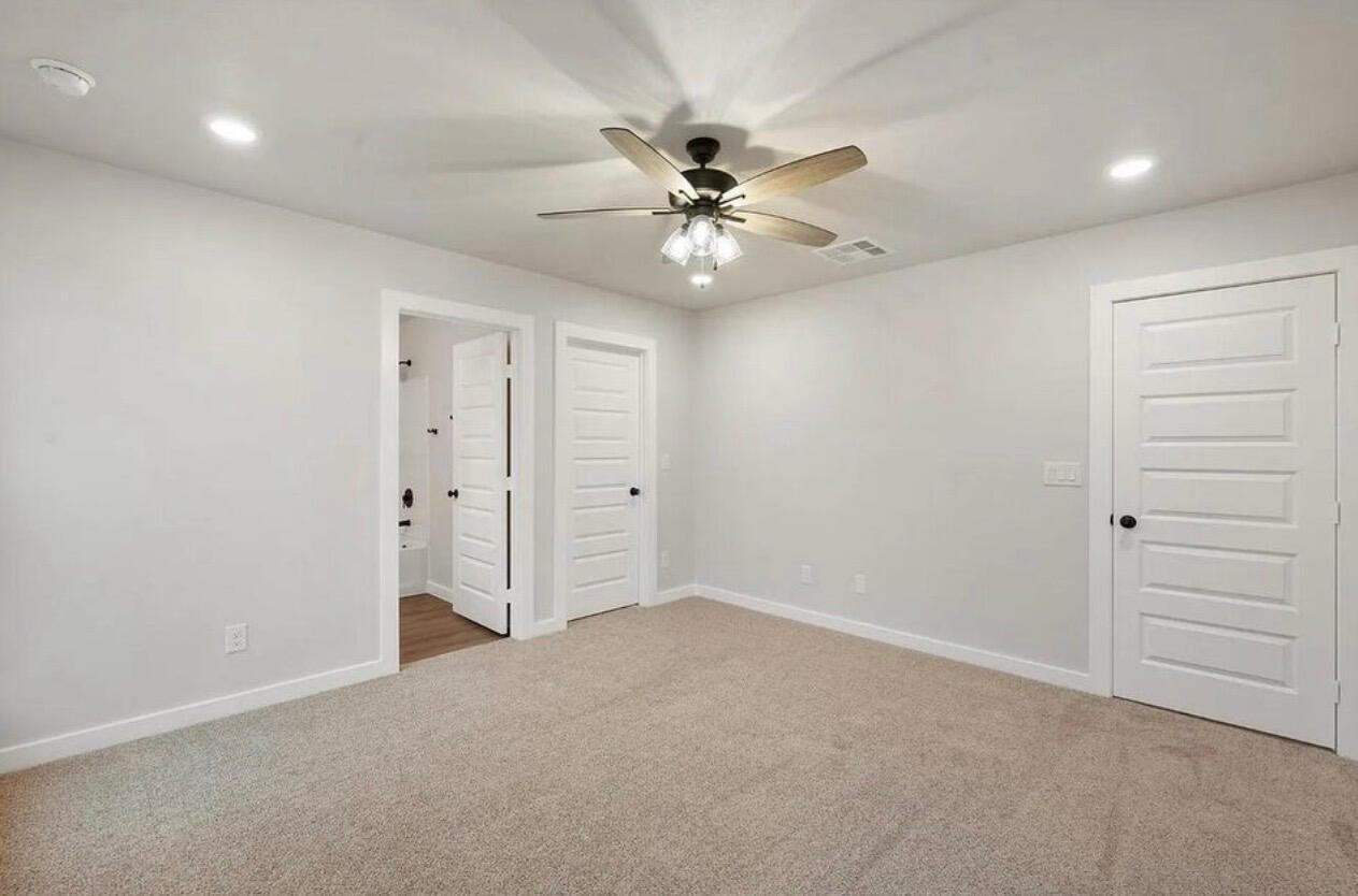 1708 145th Street Lubbock, TX 79423 - Photo 14 of 19 an empty room with closet and fan
