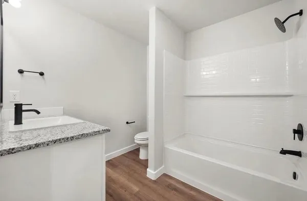 en empty room with windows and fan