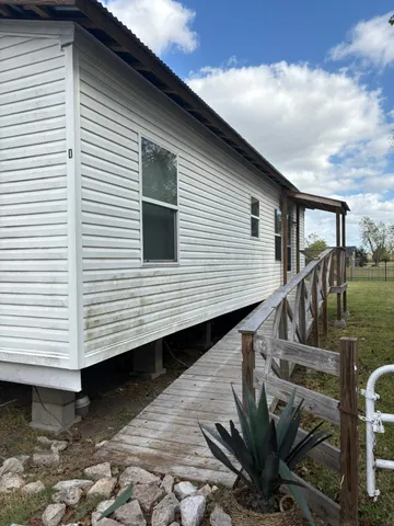 a view of a house with backyard and deck
