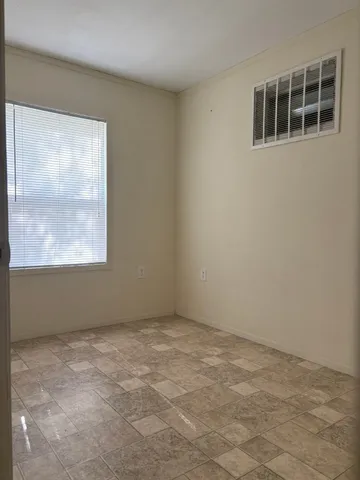 a view of an empty room with a window