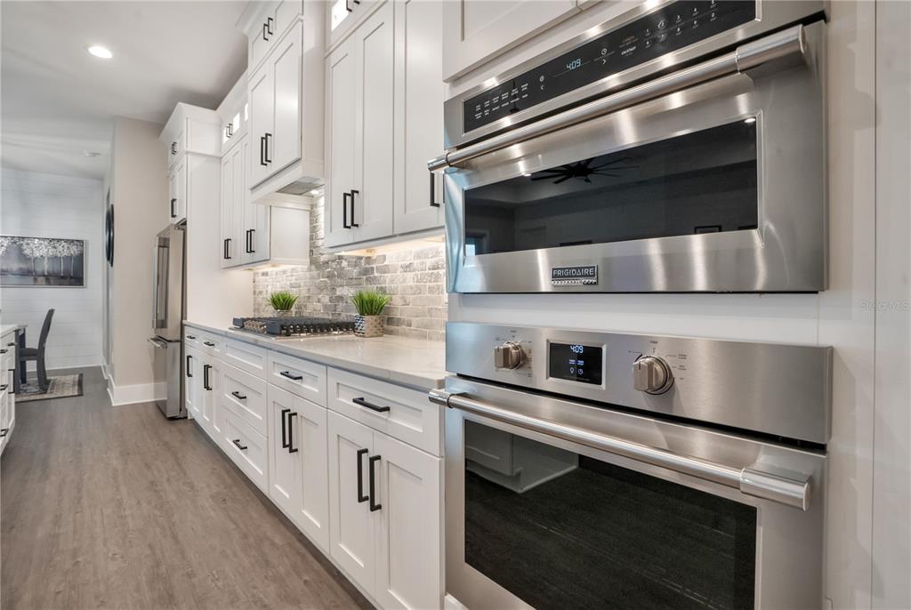 440 Palma Ceia Road Winter Haven, FL 33884 - Photo 25 of 78 a kitchen with stainless steel appliances a stove microwave and cabinets