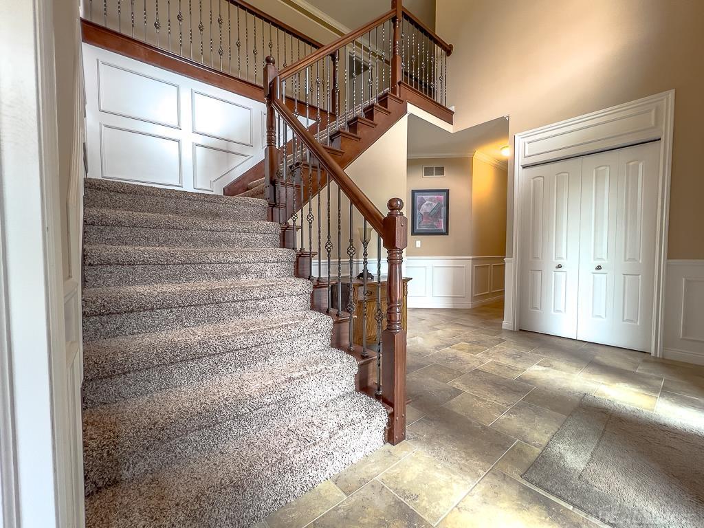 16070 Moore Park Road Macomb, MI 48044 - Photo 4 of 76 Foyer embellished generously with wainscotting, crown molding, & raised panel above doors.