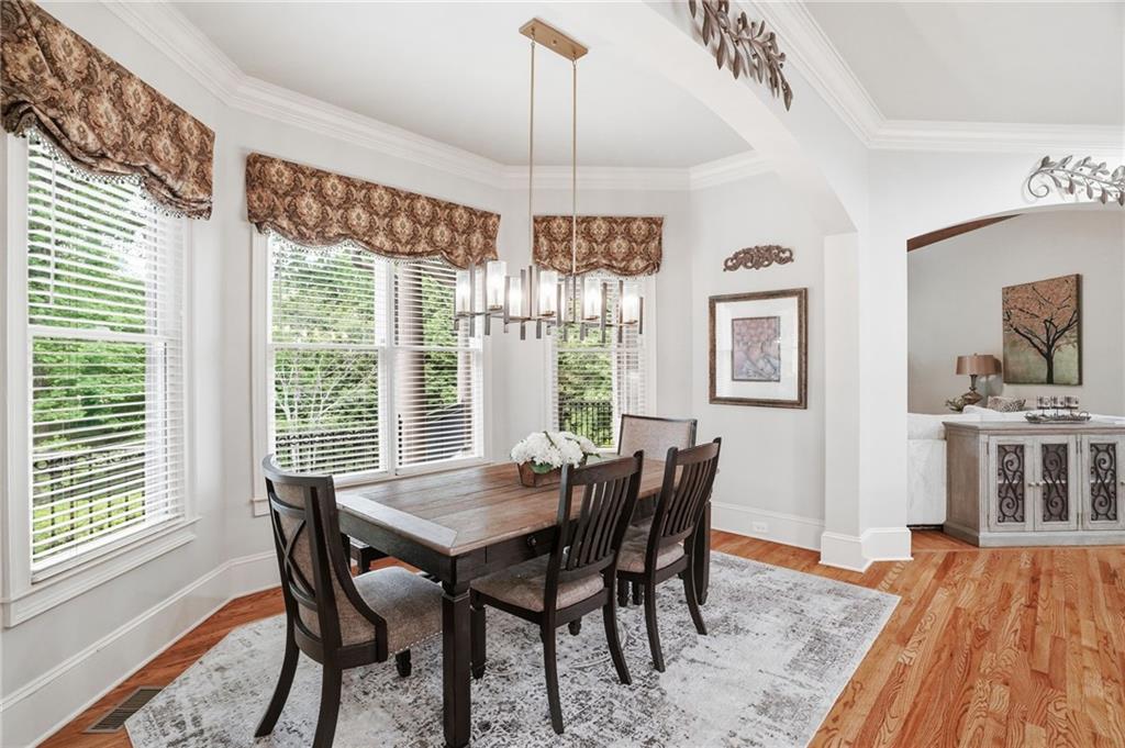 8340 Colonial Place Duluth, GA 30097 - Photo 16 of 74 a view of a dining room with furniture window and wooden floor