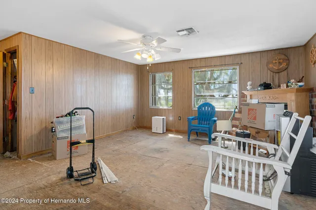 a view of a livingroom with workspace and a window