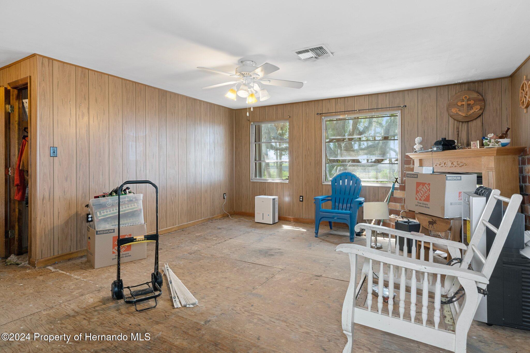 8122 Camp Lane Aripeka, FL 34679 - Photo 24 of 40 a living room with furniture a piano and a window
