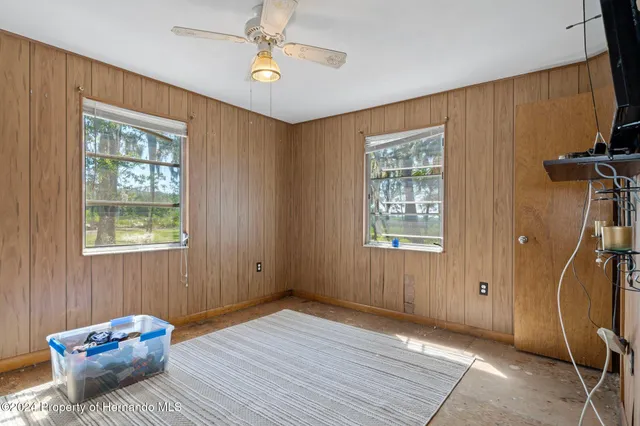 a view of a hallway with wooden floor and entryway