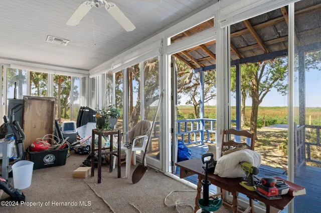a front view of a house with garden and trees