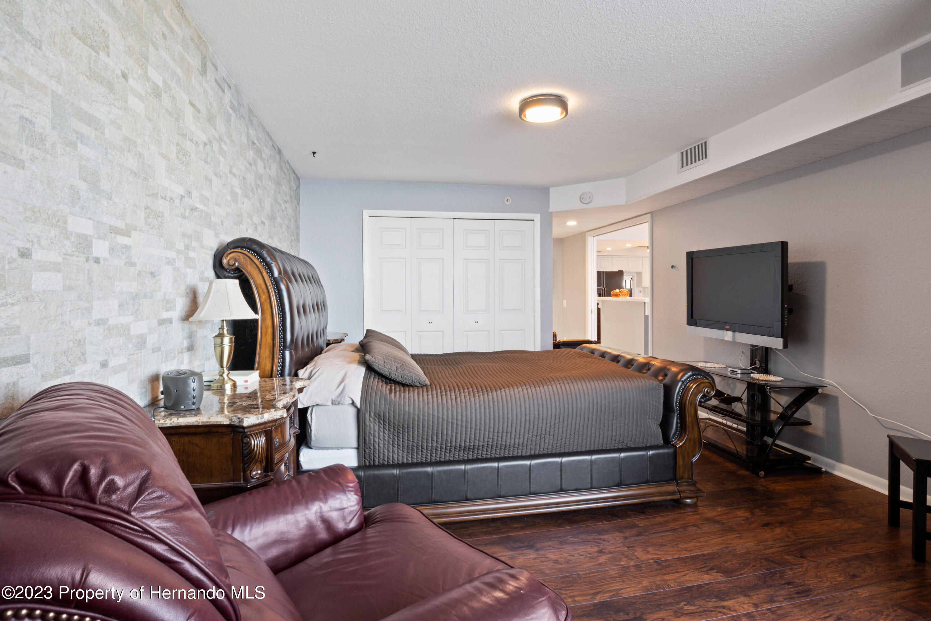6035 Sea Ranch Drive Hudson, FL 34667 - Photo 14 of 32 a bedroom with a bed and a flat screen tv