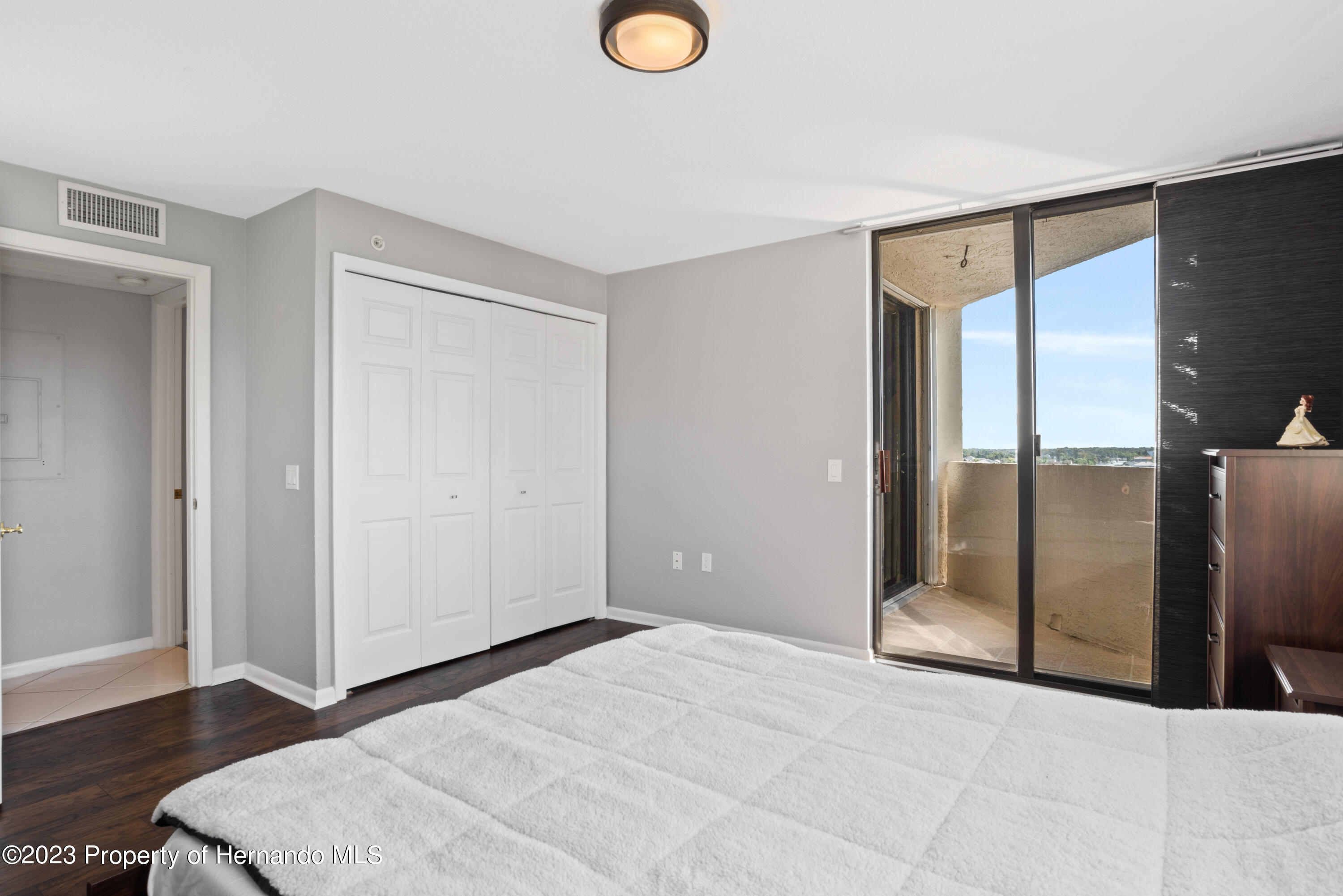 6035 Sea Ranch Drive Hudson, FL 34667 - Photo 17 of 32 a view of a room with wooden floor and sliding glass door