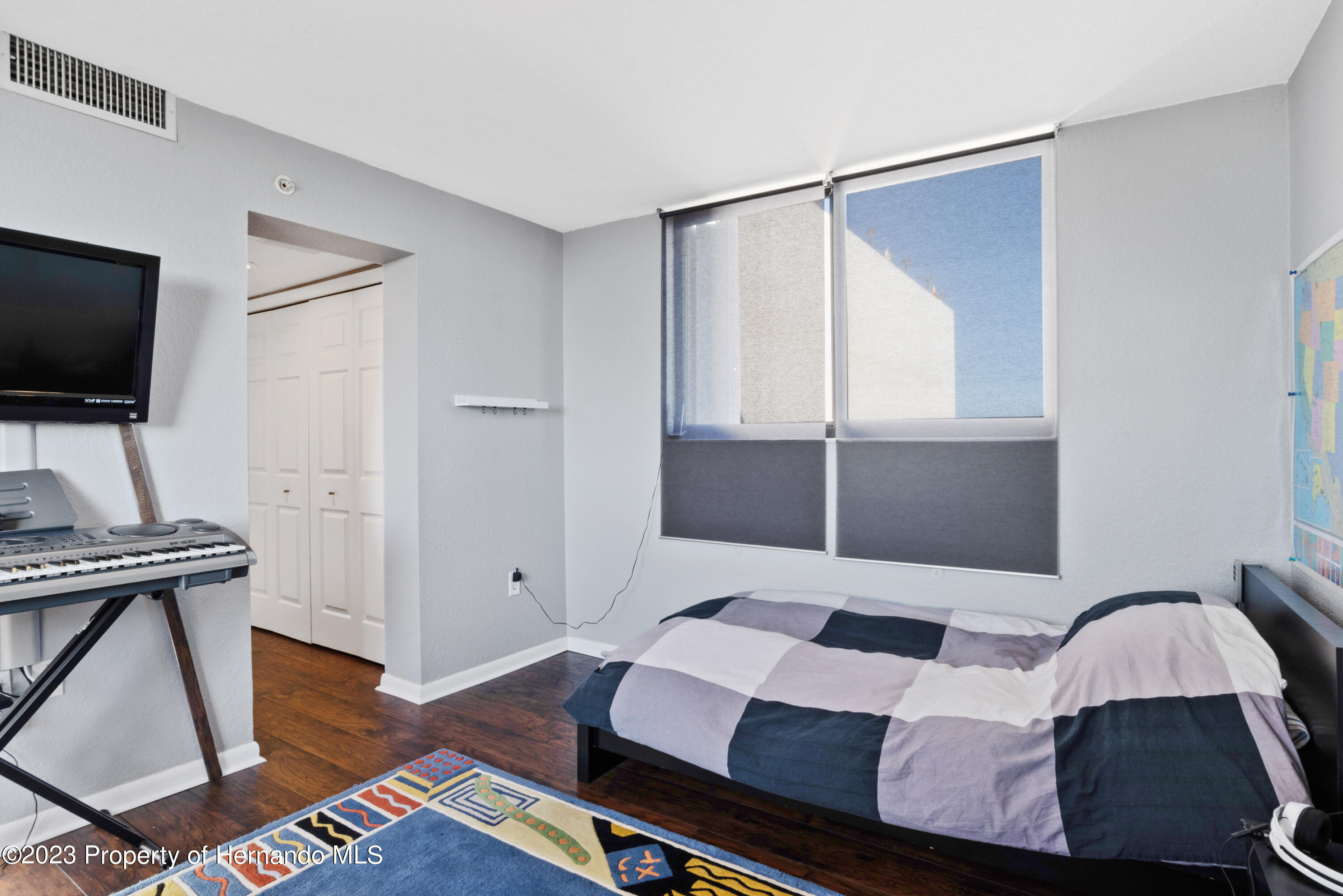 6035 Sea Ranch Drive Hudson, FL 34667 - Photo 20 of 32 a bedroom with a bed and a flat screen tv