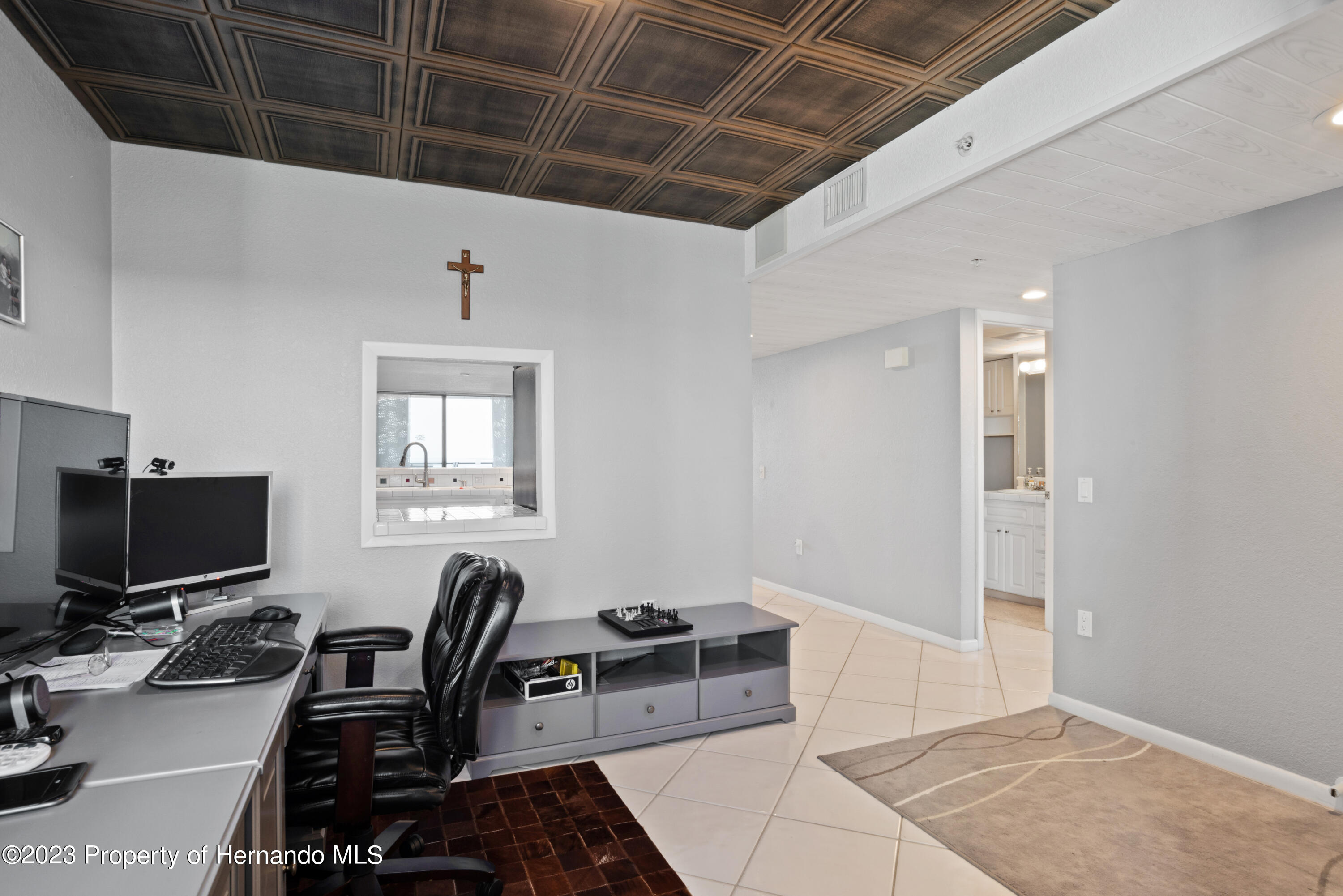 6035 Sea Ranch Drive Hudson, FL 34667 - Photo 4 of 32 a workspace with furniture and a flat screen tv