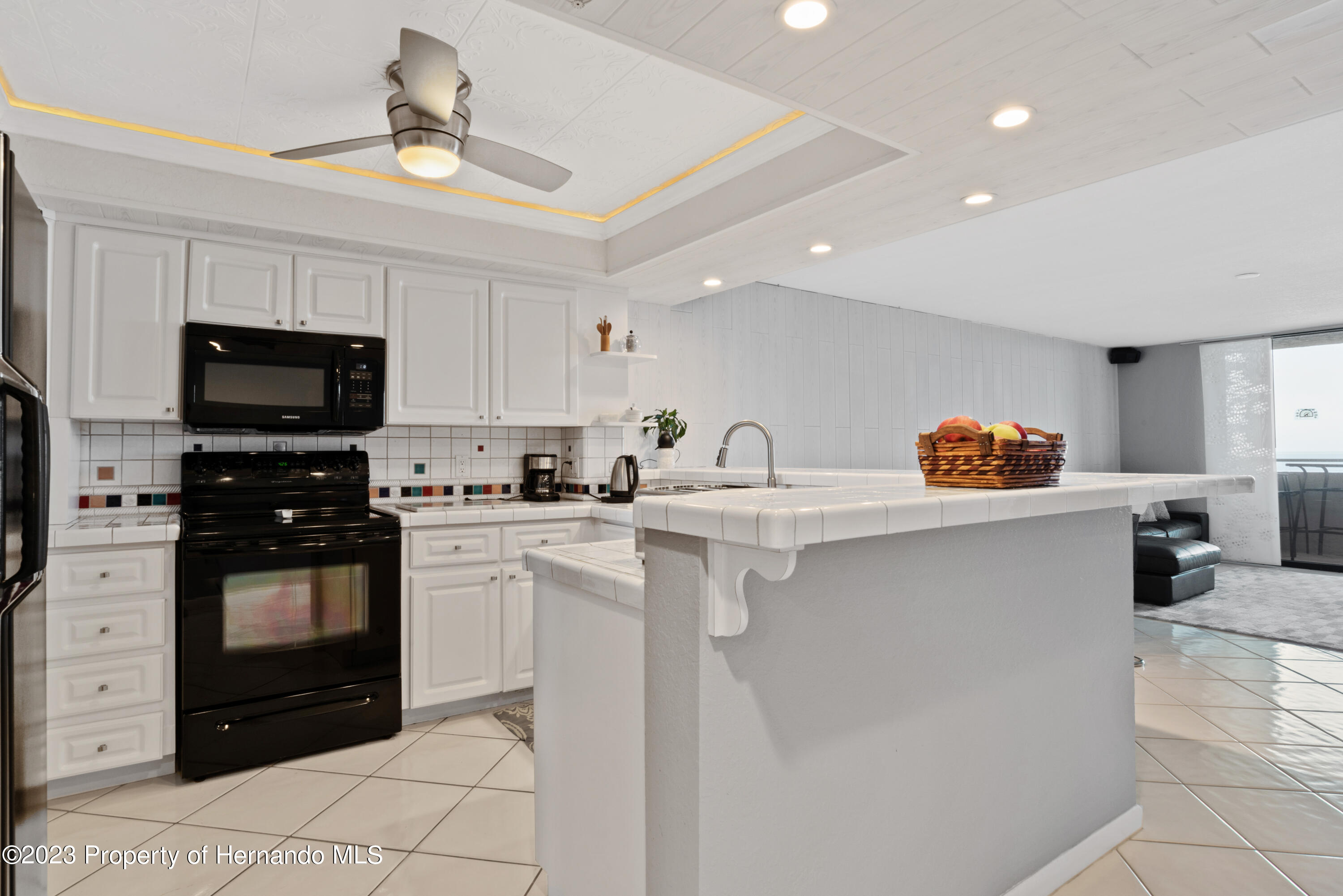 6035 Sea Ranch Drive Hudson, FL 34667 - Photo 5 of 32 a kitchen with stainless steel appliances a stove a sink and a microwave