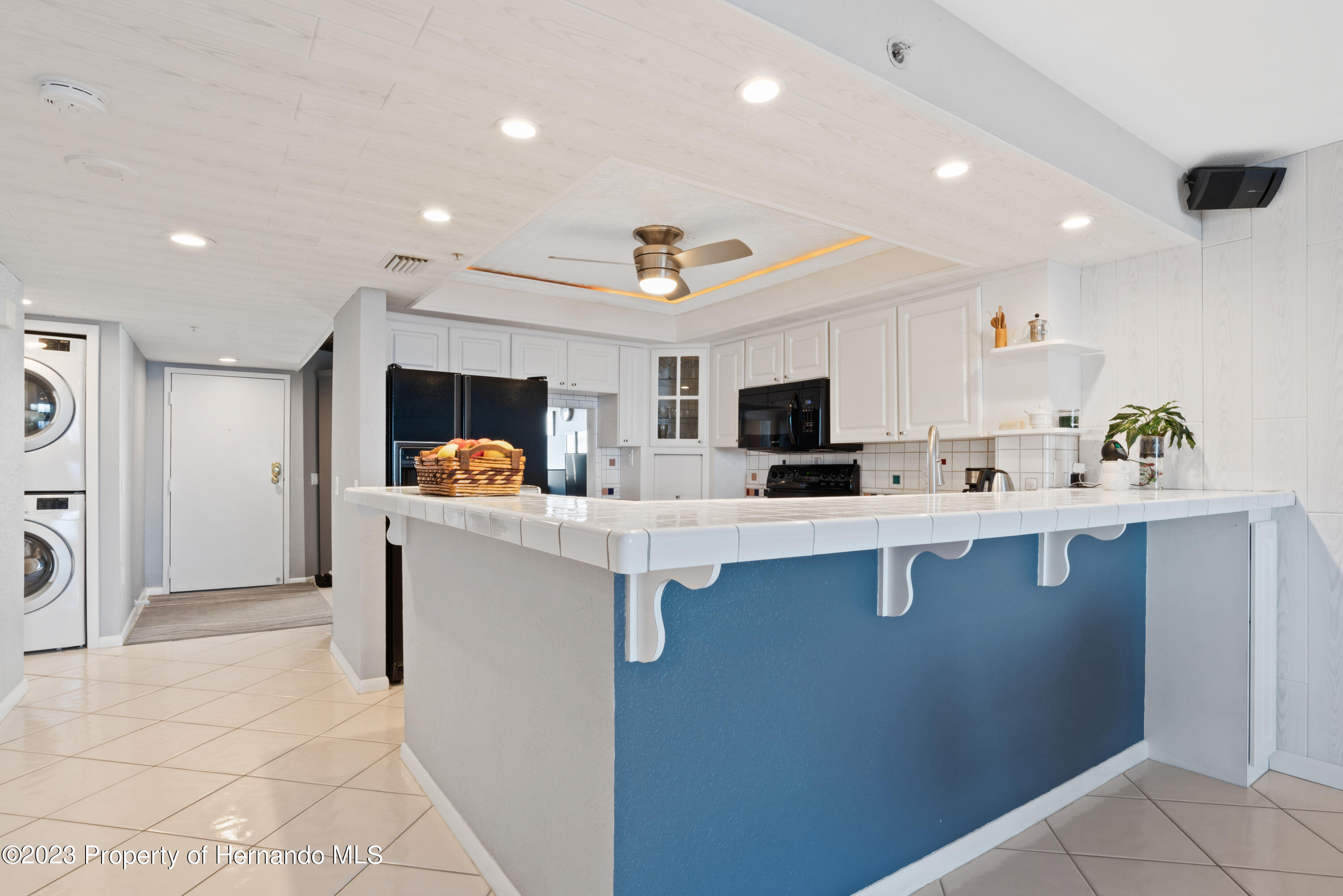 6035 Sea Ranch Drive Hudson, FL 34667 - Photo 6 of 32 a kitchen with stainless steel appliances granite countertop a sink and a refrigerator