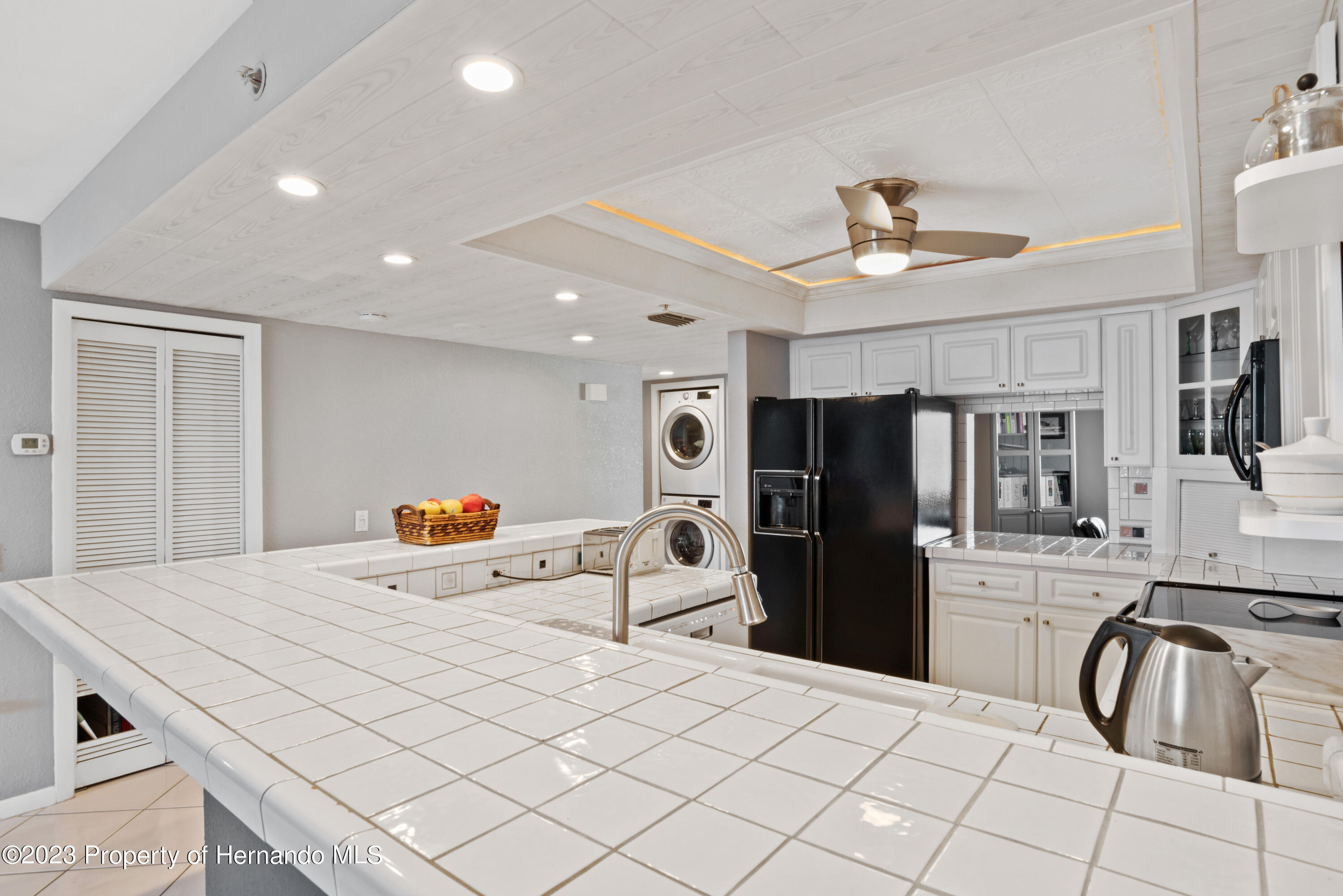 6035 Sea Ranch Drive Hudson, FL 34667 - Photo 7 of 32 a kitchen with stainless steel appliances a refrigerator and microwave