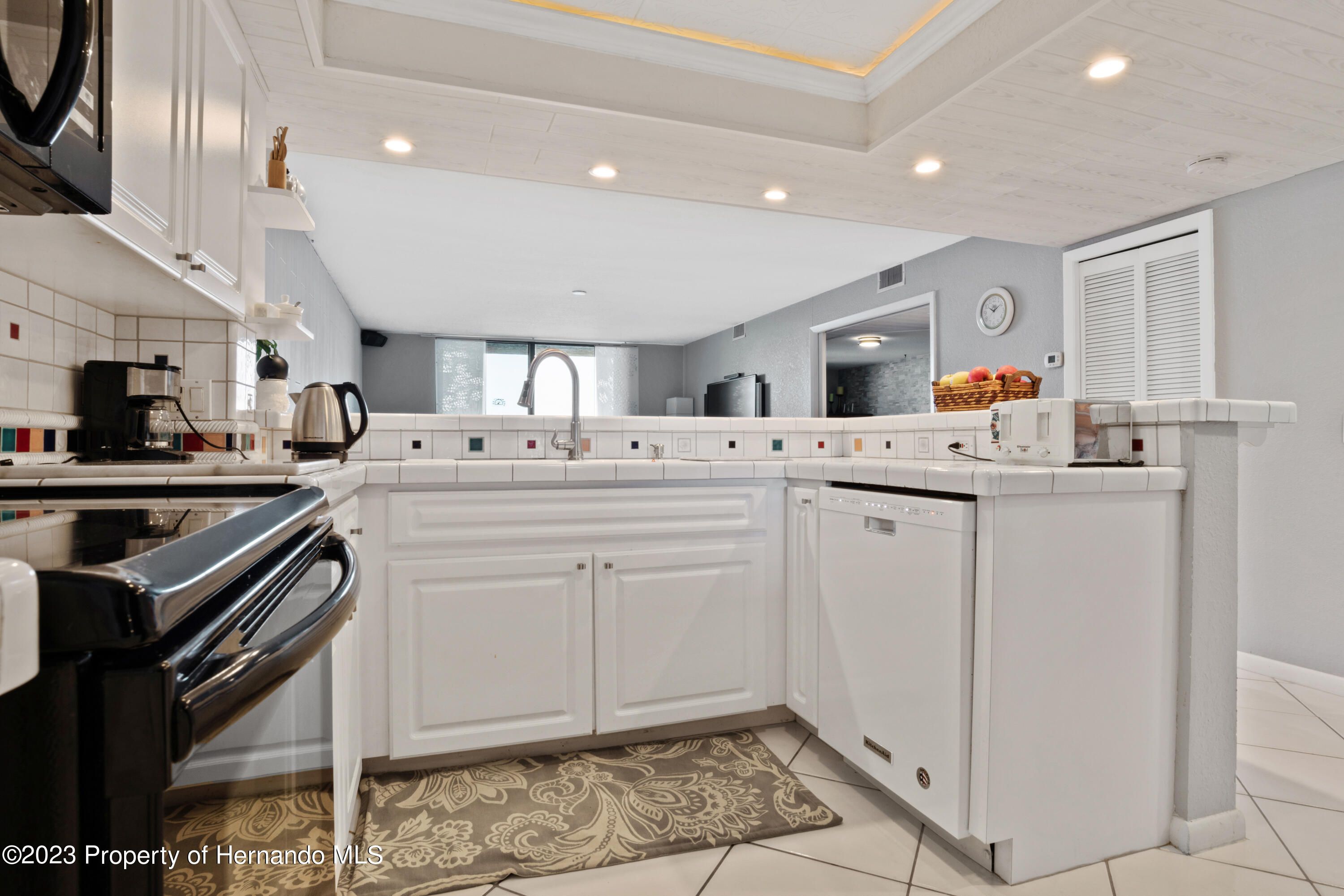6035 Sea Ranch Drive Hudson, FL 34667 - Photo 8 of 32 a kitchen that has a lot of cabinets in it and appliances