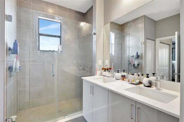 a bathroom with double sink and a mirror