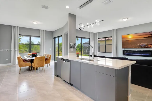 a view of a kitchen with kitchen island a sink and a large window