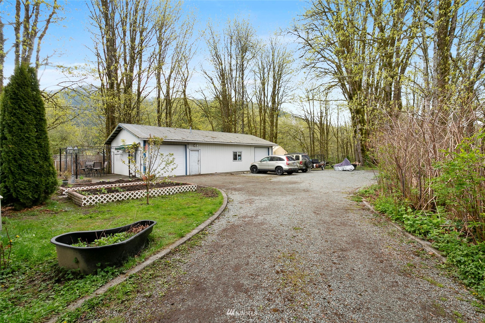 5191 Wickersham Road Acme, WA 98220 - Photo 22 of 23 a view of a house with backyard and sitting area