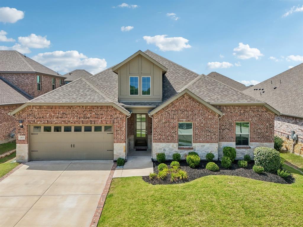 3815 Devine Drive Rowlett, TX 75089 - Photo 1 of 1 a front view of a house with a yard and potted plants