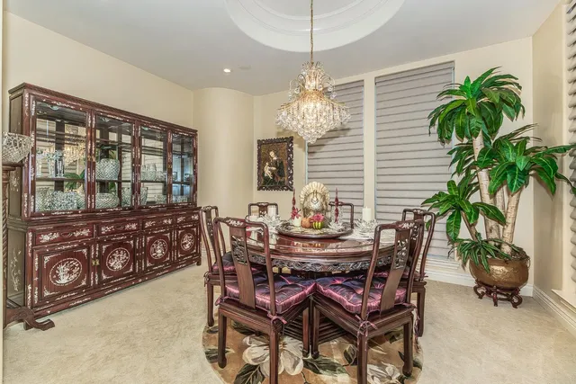a dining room with furniture potted plants and wooden floor