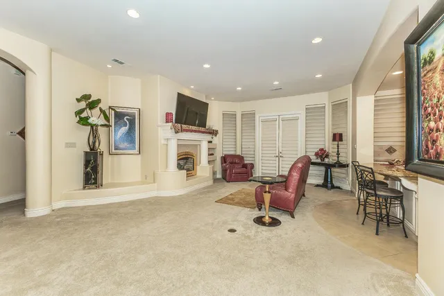 a living room with furniture gym equipment and a window