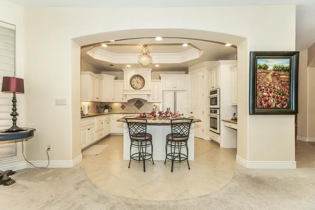 a kitchen with stainless steel appliances kitchen island granite countertop a sink and cabinets