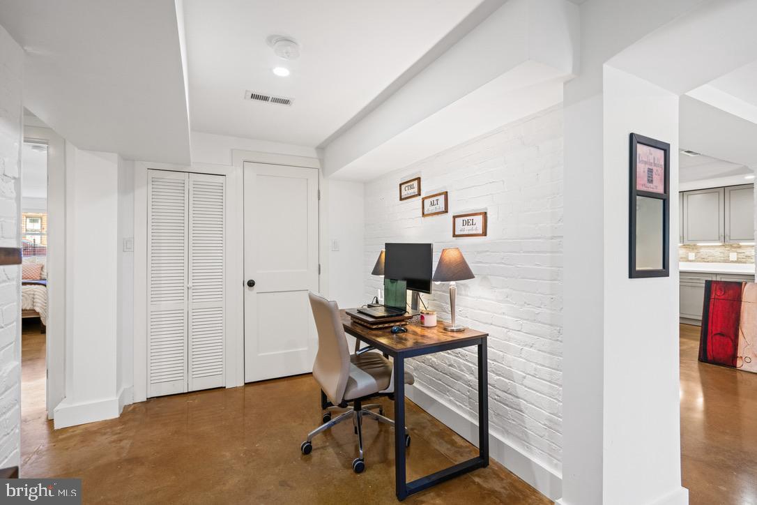 1239 Simms Place Northeast, Unit 5 Washington, DC 20002 - Photo 16 of 31 a view of a workspace with furniture and a window