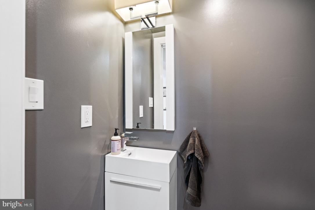 1239 Simms Place Northeast, Unit 5 Washington, DC 20002 - Photo 18 of 31 a bathroom with a sink and a mirror