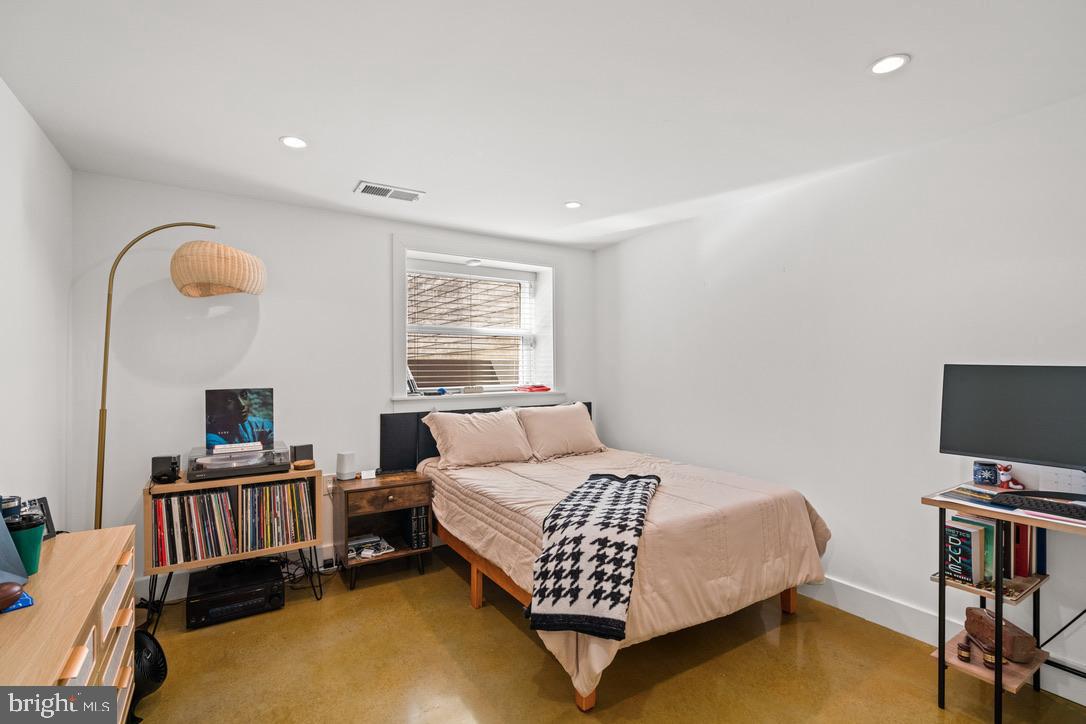 1239 Simms Place Northeast, Unit 5 Washington, DC 20002 - Photo 19 of 31 a bedroom with a bed and a flat screen tv