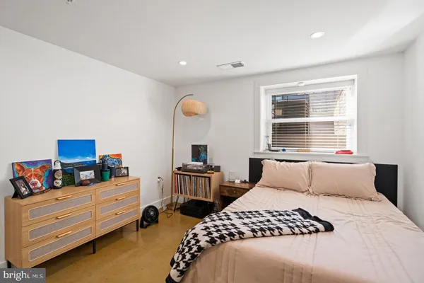 a bedroom with a bed and a dresser