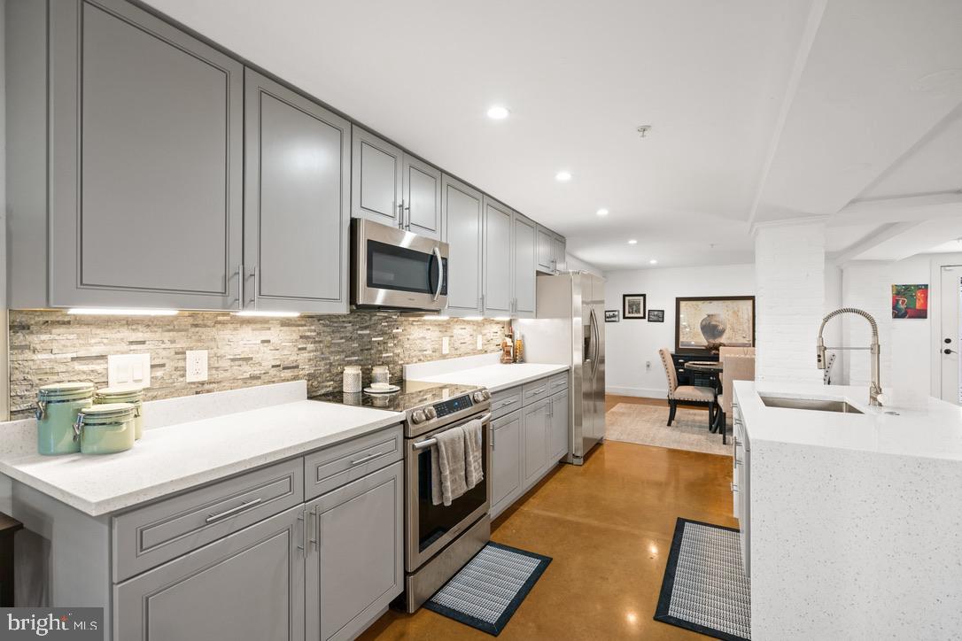 1239 Simms Place Northeast, Unit 5 Washington, DC 20002 - Photo 2 of 31 a kitchen with a sink stove and cabinets
