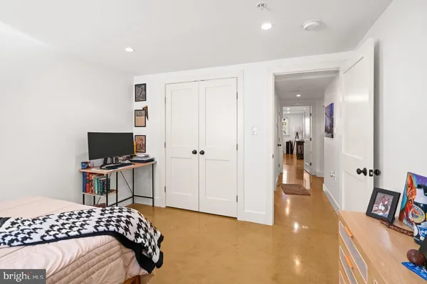a bedroom with a bed and flat screen tv