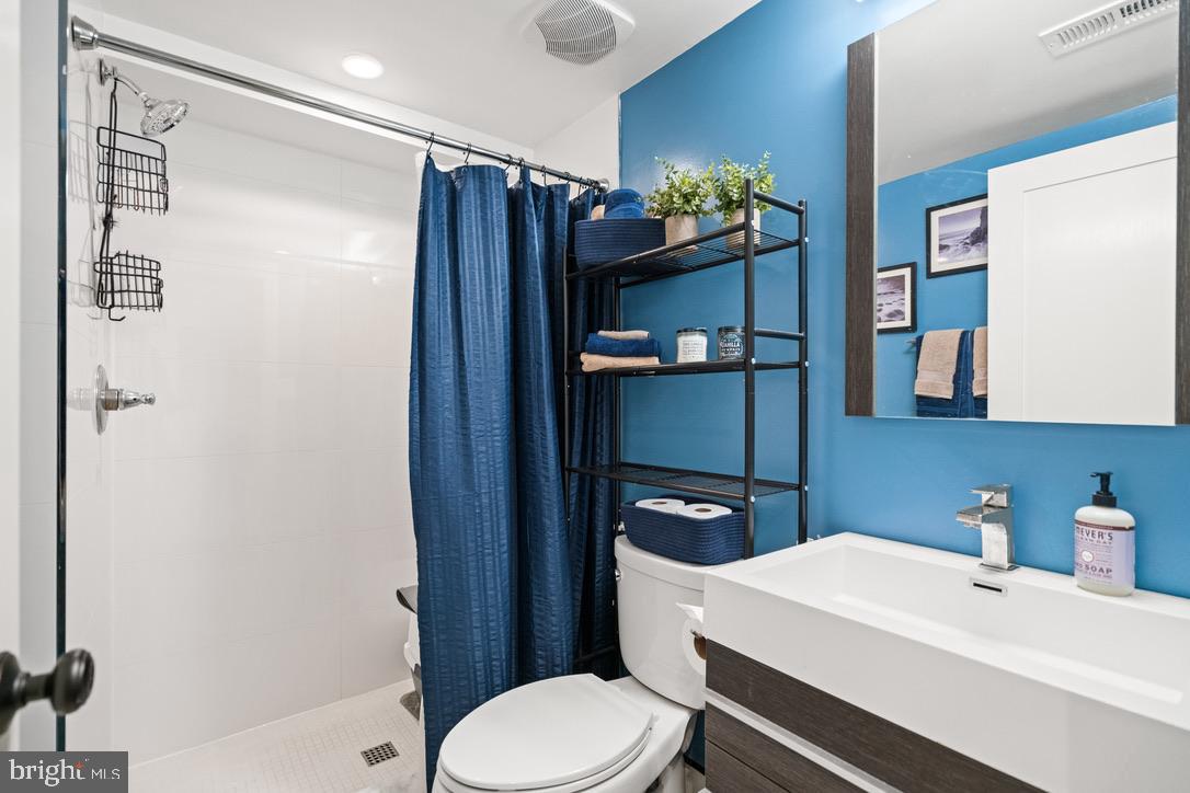 1239 Simms Place Northeast, Unit 5 Washington, DC 20002 - Photo 22 of 31 a bathroom with a sink toilet and mirror