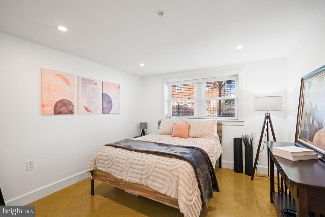 1239 Simms Place Northeast, Unit 5 Washington, DC 20002 - Photo 23 of 31 a bedroom with a bed and a table