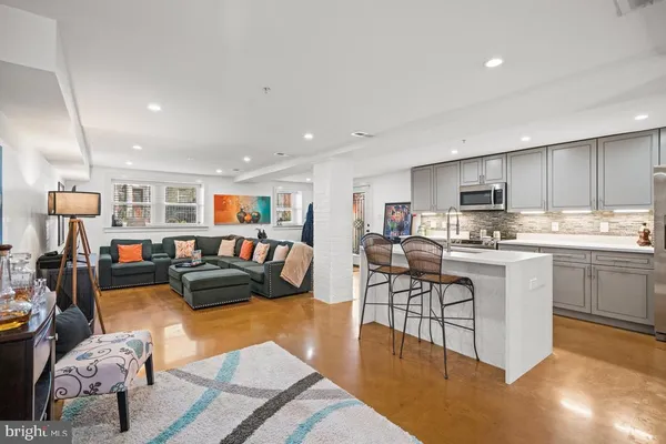 a living room with stainless steel appliances furniture or couch and a dining table