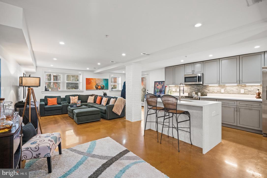 1239 Simms Place Northeast, Unit 5 Washington, DC 20002 - Photo 3 of 31 a living room with stainless steel appliances furniture or couch and a dining table