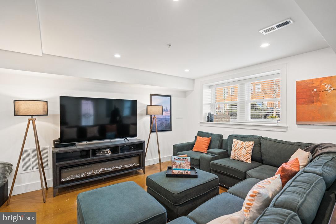 1239 Simms Place Northeast, Unit 5 Washington, DC 20002 - Photo 6 of 31 a living room with furniture and a flat screen tv