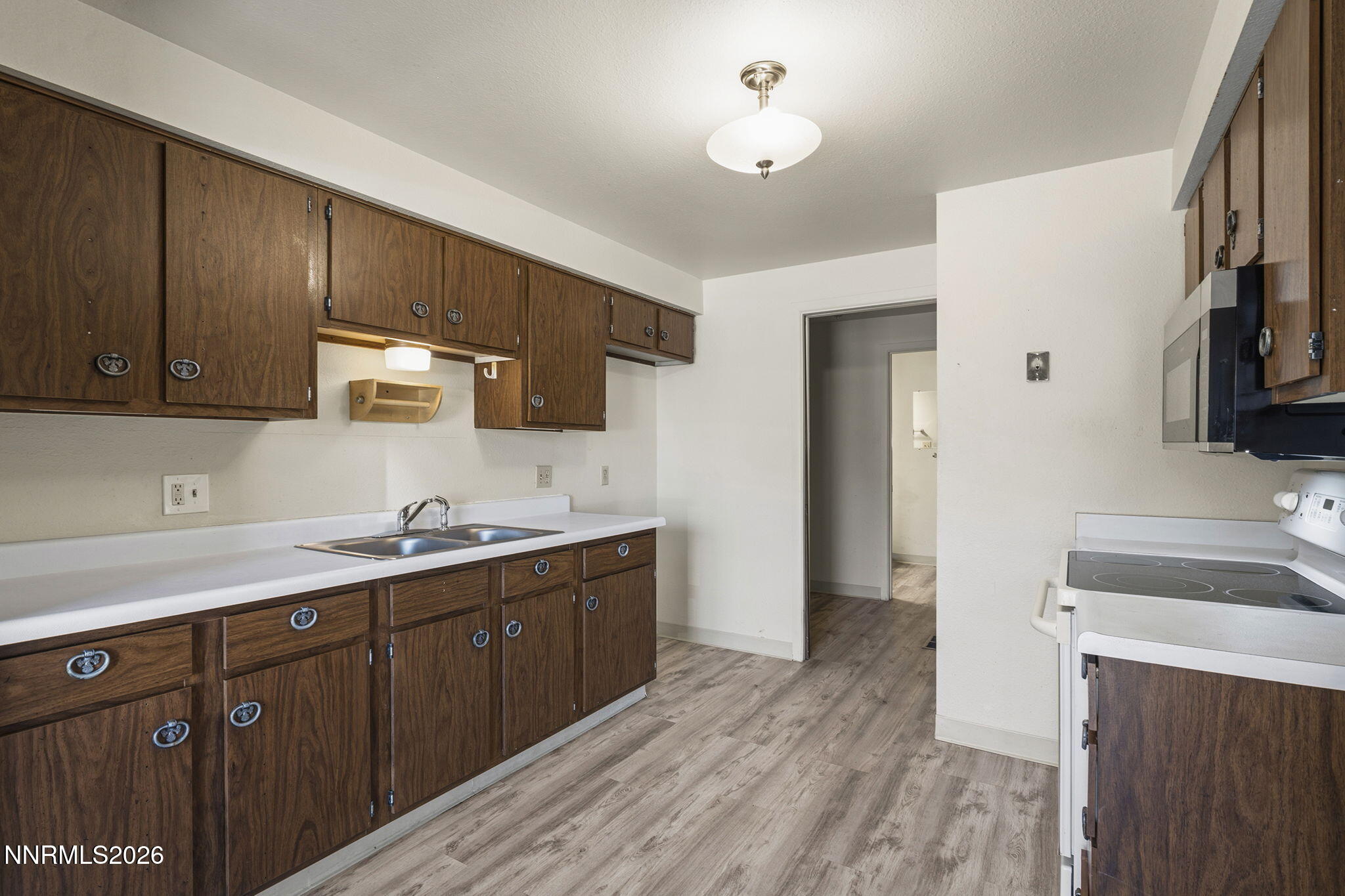 2153 Oppio Street Sparks, NV 89431 - Photo 11 of 23 a kitchen with a sink stove and cabinets