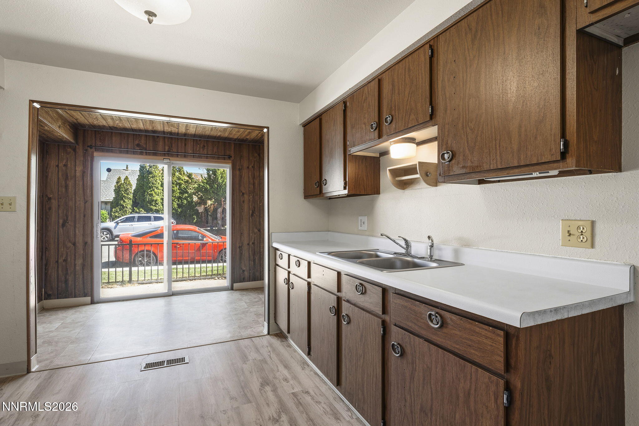 2153 Oppio Street Sparks, NV 89431 - Photo 13 of 23 a kitchen with a sink a stove cabinets and a wooden floor