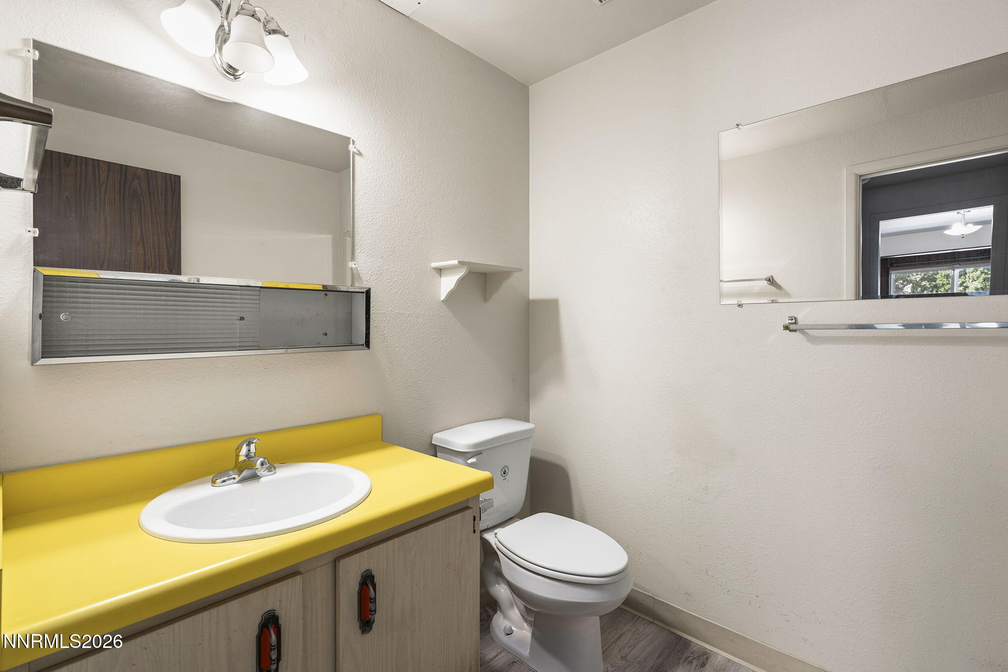 2153 Oppio Street Sparks, NV 89431 - Photo 15 of 23 a bathroom with a sink a toilet and mirror