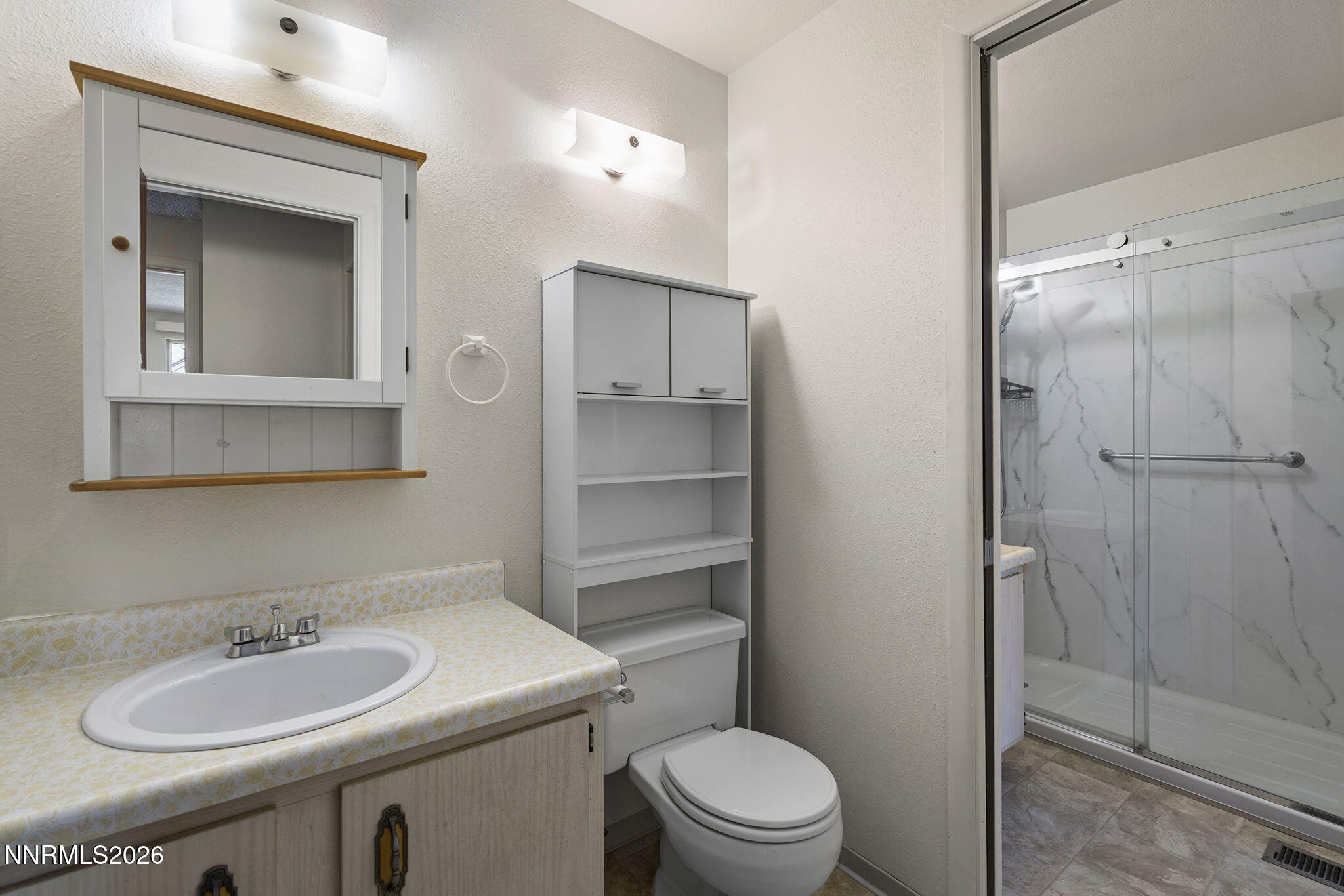 2153 Oppio Street Sparks, NV 89431 - Photo 18 of 23 a bathroom with a toilet sink vanity granite and shower