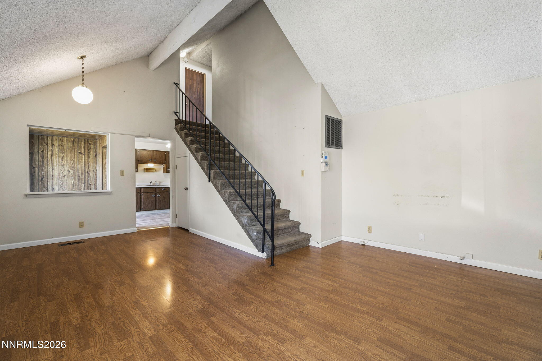 2153 Oppio Street Sparks, NV 89431 - Photo 7 of 23 a view of an empty room with wooden floor and stairs