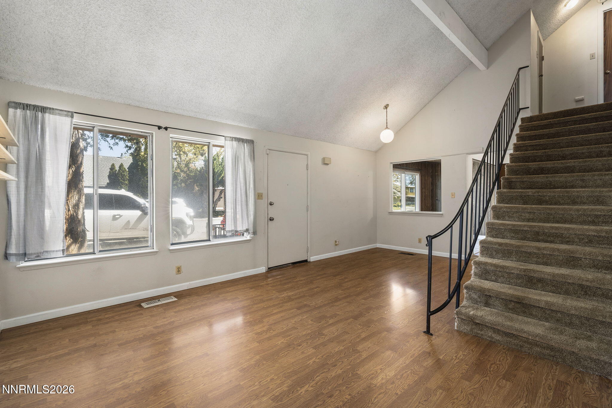 2153 Oppio Street Sparks, NV 89431 - Photo 8 of 23 an empty room with wooden floor and windows