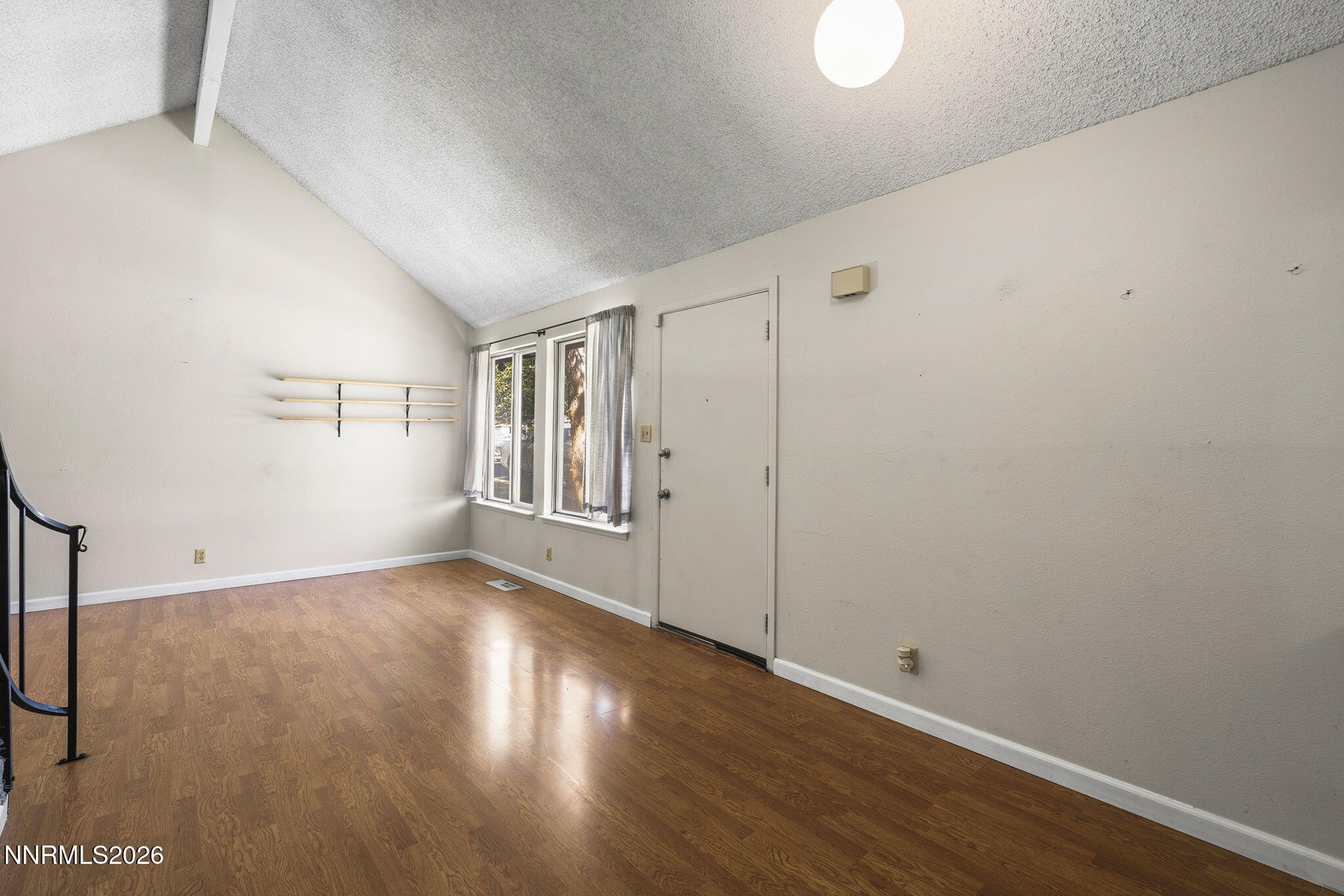 2153 Oppio Street Sparks, NV 89431 - Photo 10 of 23 a view of an empty room with wooden floor and a window