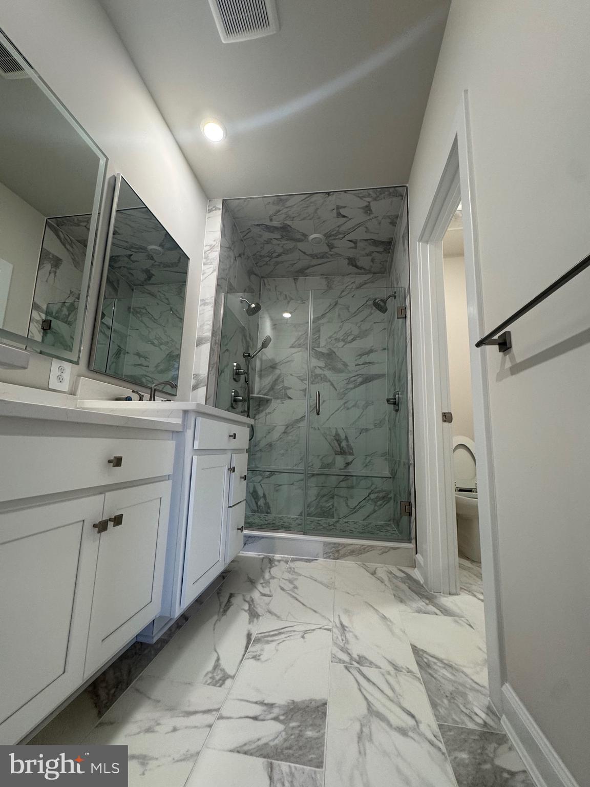 3775 Mayors Way Fairfax, VA 22030 - Photo 16 of 42 a bathroom with a granite countertop sink a toilet and shower