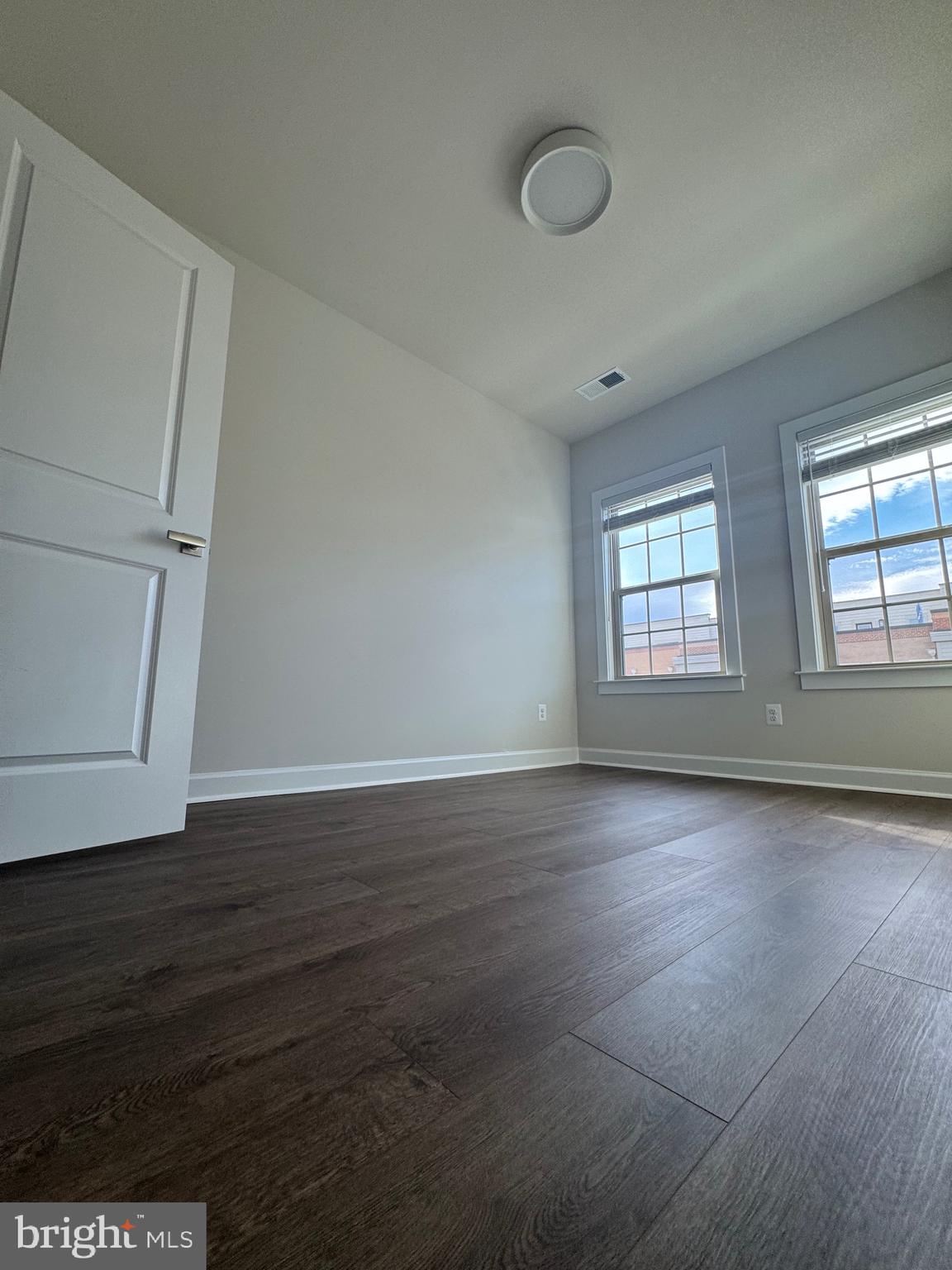 3775 Mayors Way Fairfax, VA 22030 - Photo 26 of 42 a view of an empty room with wooden floor and a window