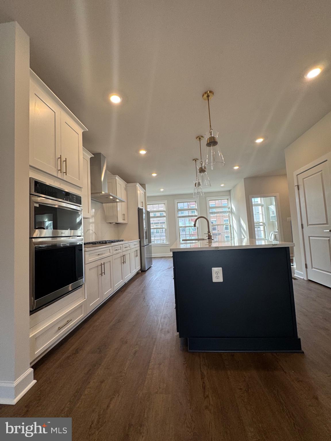 3775 Mayors Way Fairfax, VA 22030 - Photo 34 of 42 a view of a kitchen with stainless steel appliances granite countertop a stove a microwave and a refrigerator